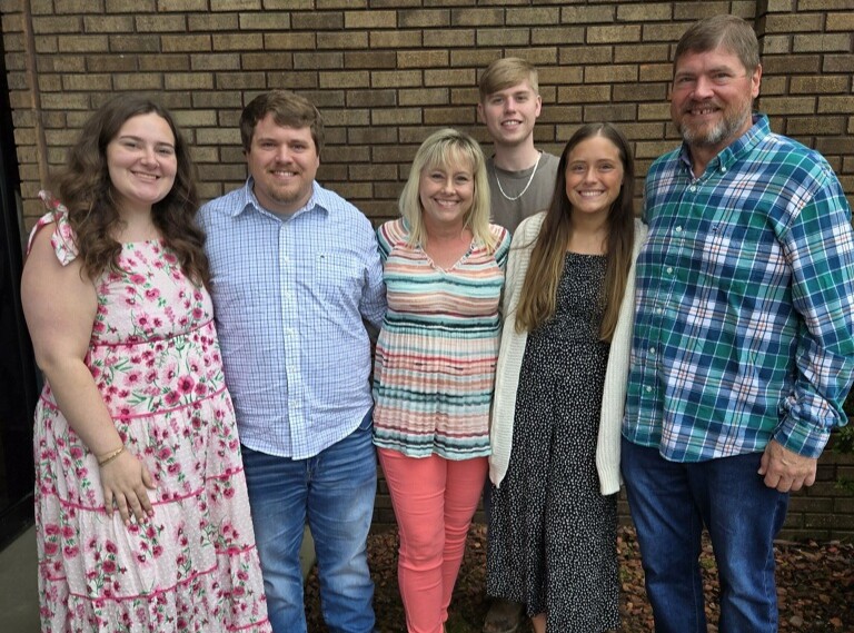 Placeholder: Family by a fireplace